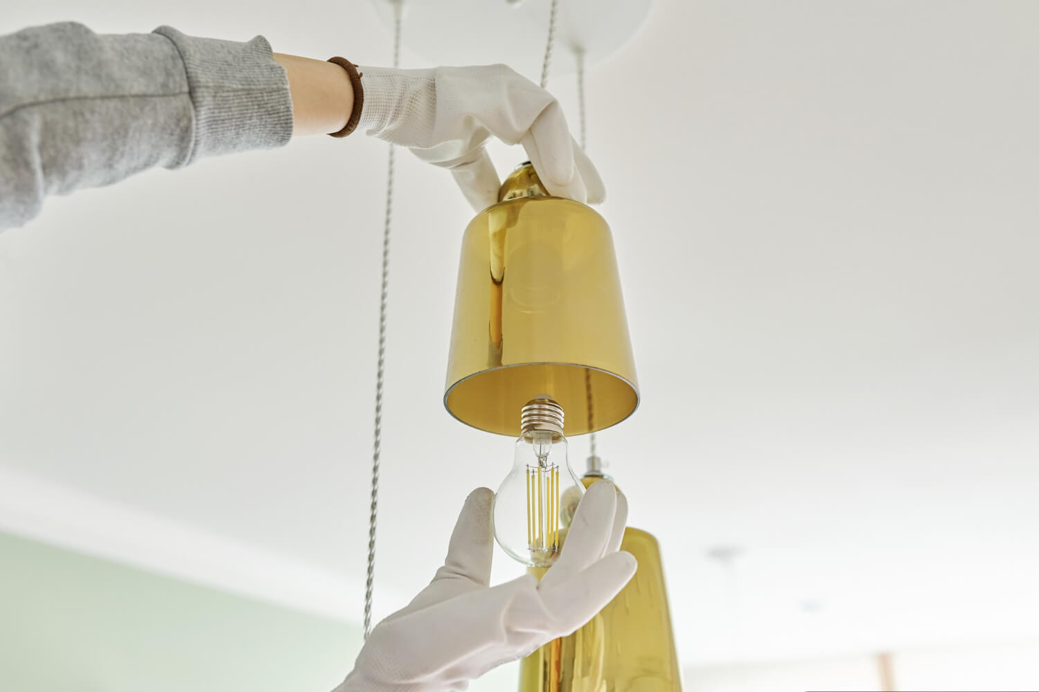 hands-installing-led-bulb-lamp-chandelier (1) (1)